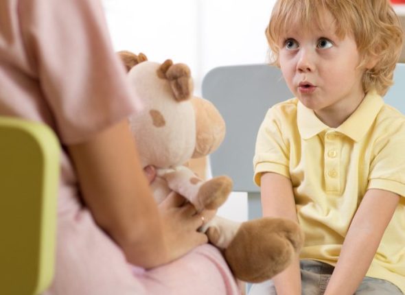 Cute little child boy at speech therapist office