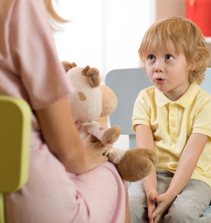 Cute little child boy at speech therapist office