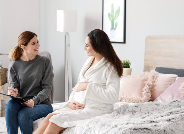 Doula with pregnant woman at home