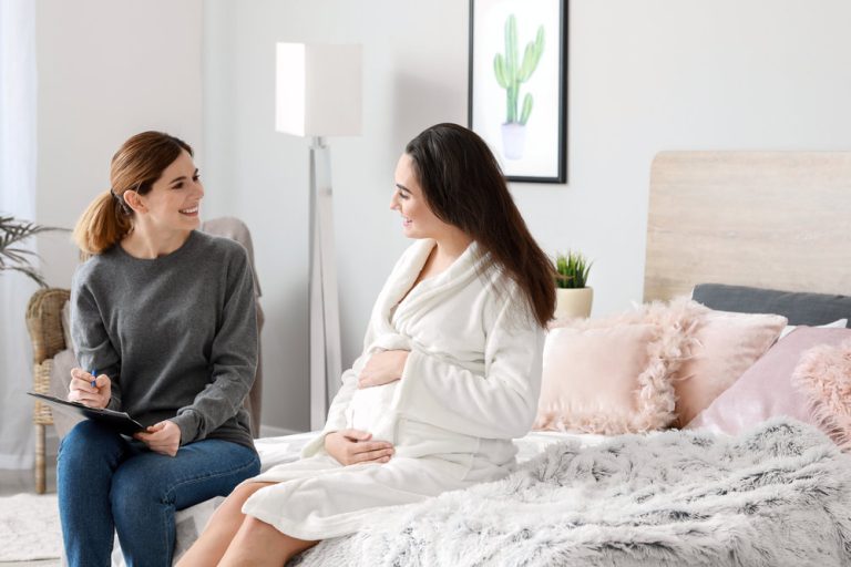 Doula with pregnant woman at home