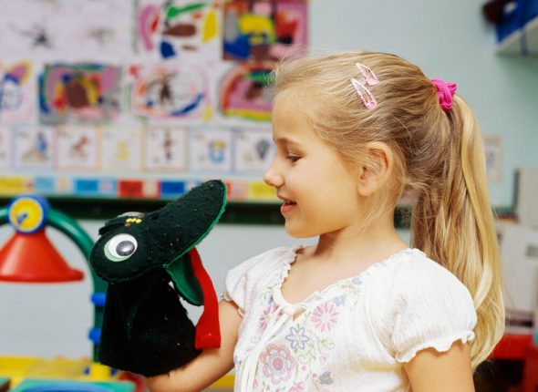 Close-up of a girl holding a hand puppet