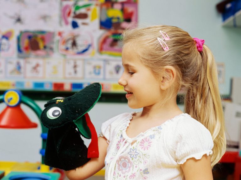 Close-up of a girl holding a hand puppet